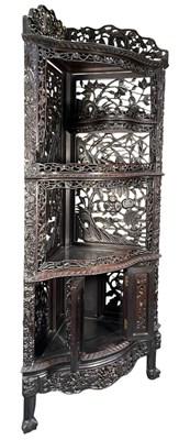Lot 304 - QING DYNASTY CHINESE DARK WOOD OPEN WORK CORNER CABINET 清代实木雕刻角柜