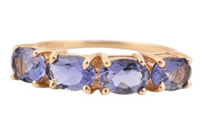 Lot 167 - HALLMARKED 14CT GOLD & TANZANITE FOUR STONE RING