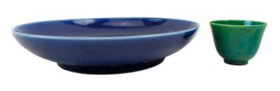 Lot 46 - CHINESE BLUE GLAZED MONOCHROME CHARGER PLATE & A GREEN GLAZED TEACUP 霁蓝釉盘和绿釉茶杯