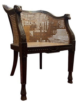 Lot 560 - REGENCY INSPIRED MAHOGANY & CANED BERGERE LIBRARY ARMCHAIR