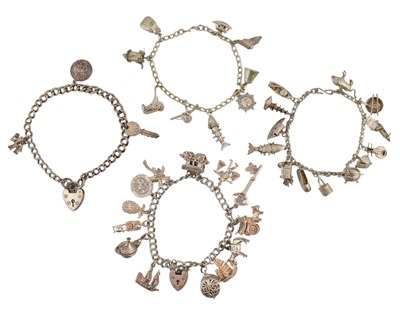 Lot 577 - A COLLECTION OF FOUR VINTAGE CHARM BRACELETS